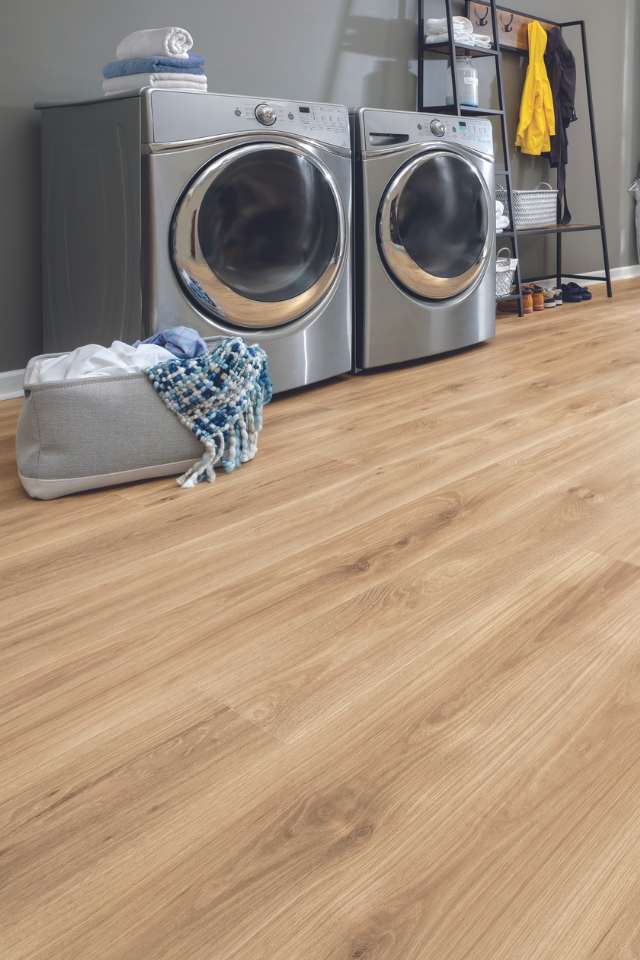 white oak look waterproof laminate flooring in modern laundry room with gray walls